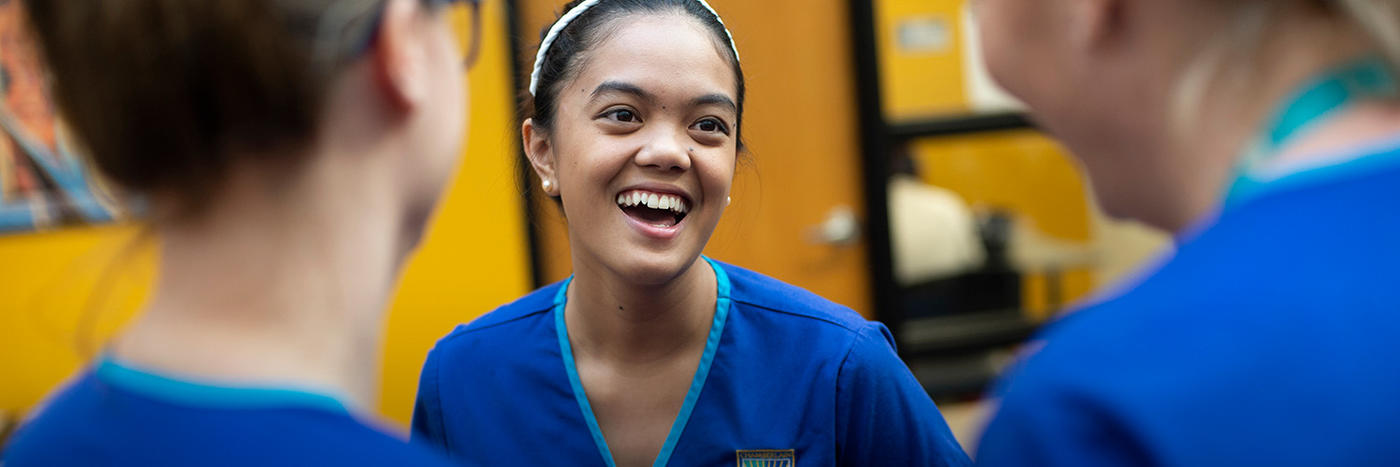 Smiling nurse in clinical setting