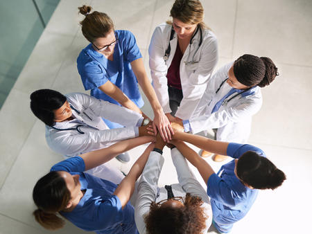 Nurses Supporting Each Other in a Huddle