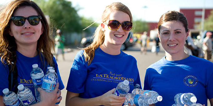students at an event passing out water bottles