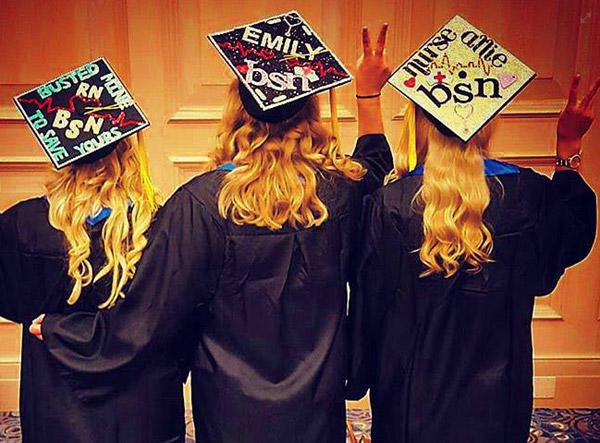 chamberlain graduates pose with decorated graduate caps