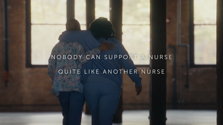 "Nobody can support a nurse quite like another nurse" Two nurses walking shoulder to shoulder