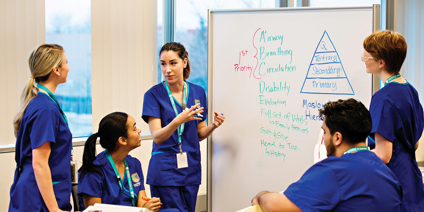 nurses gathered around a whiteboard