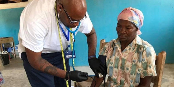 Nurse taking blood pressure from patient