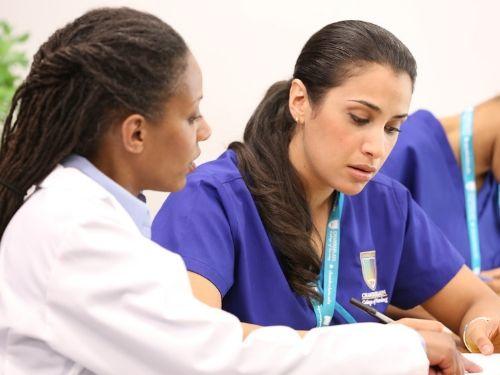 Chamberlain nursing student with instructor in a classroom